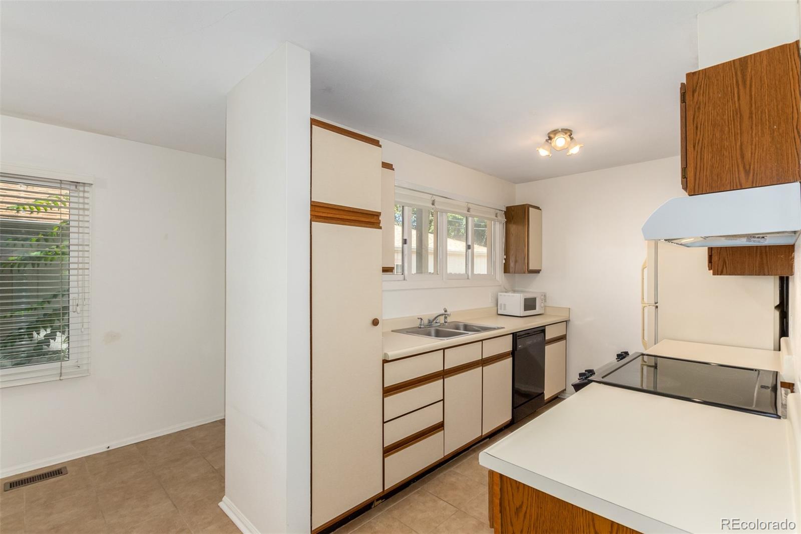 515 Cook Street Denver, CO 80206 - Photo 19 of 40 a kitchen with a sink stove and refrigerator