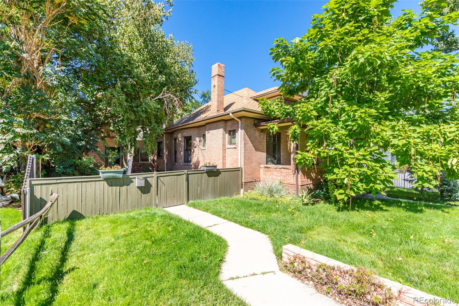 515 Cook Street Denver, CO 80206 - Photo 2 of 40 a view of a house with a yard and sitting area