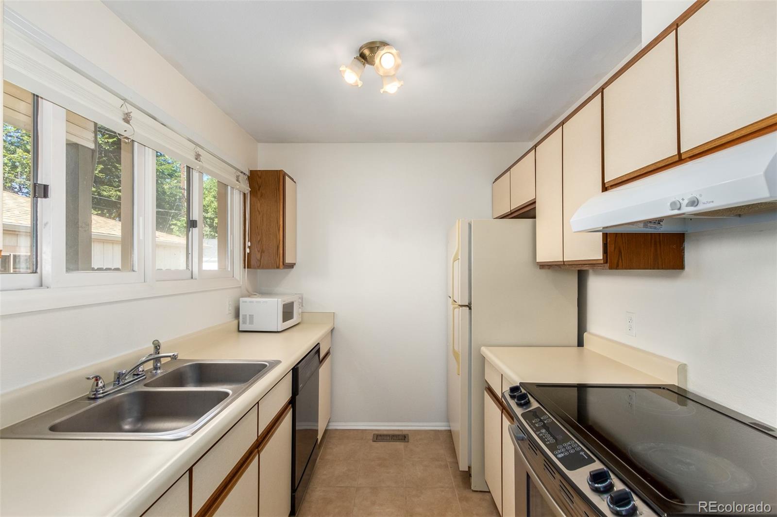 515 Cook Street Denver, CO 80206 - Photo 22 of 40 a kitchen with sink cabinets and stove