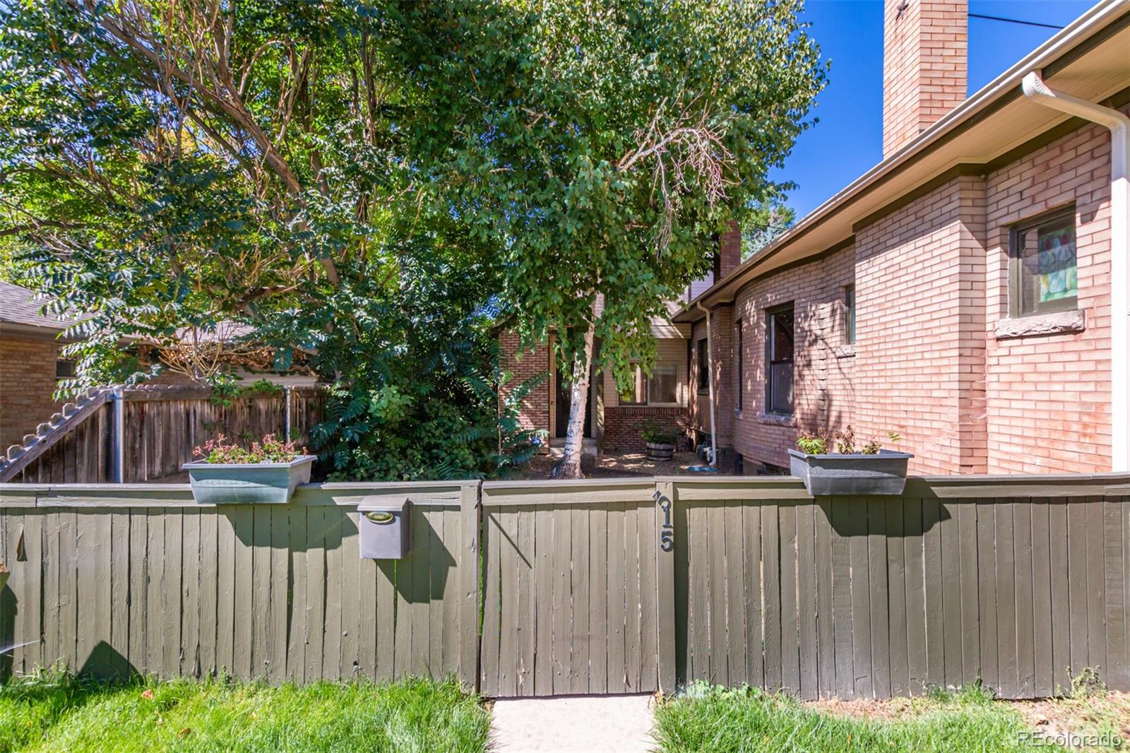 515 Cook Street Denver, CO 80206 - Photo 3 of 40 a view of a house with a wooden fence