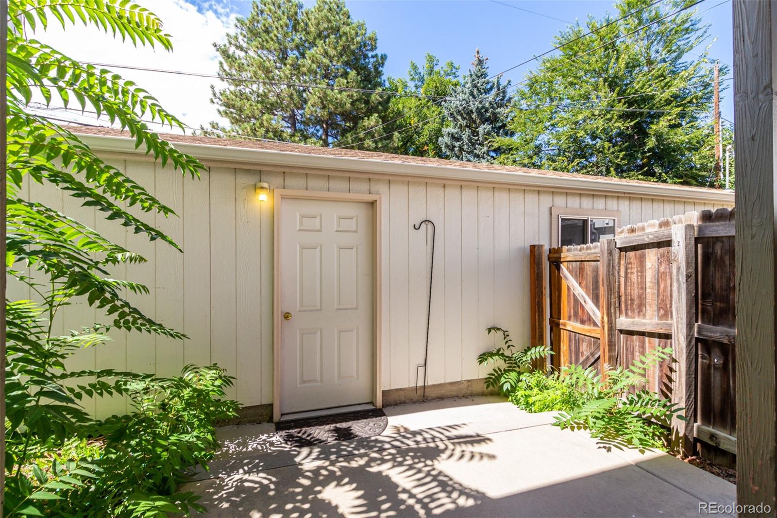 515 Cook Street Denver, CO 80206 - Photo 36 of 40 a view of a small house with potted plants in front of door