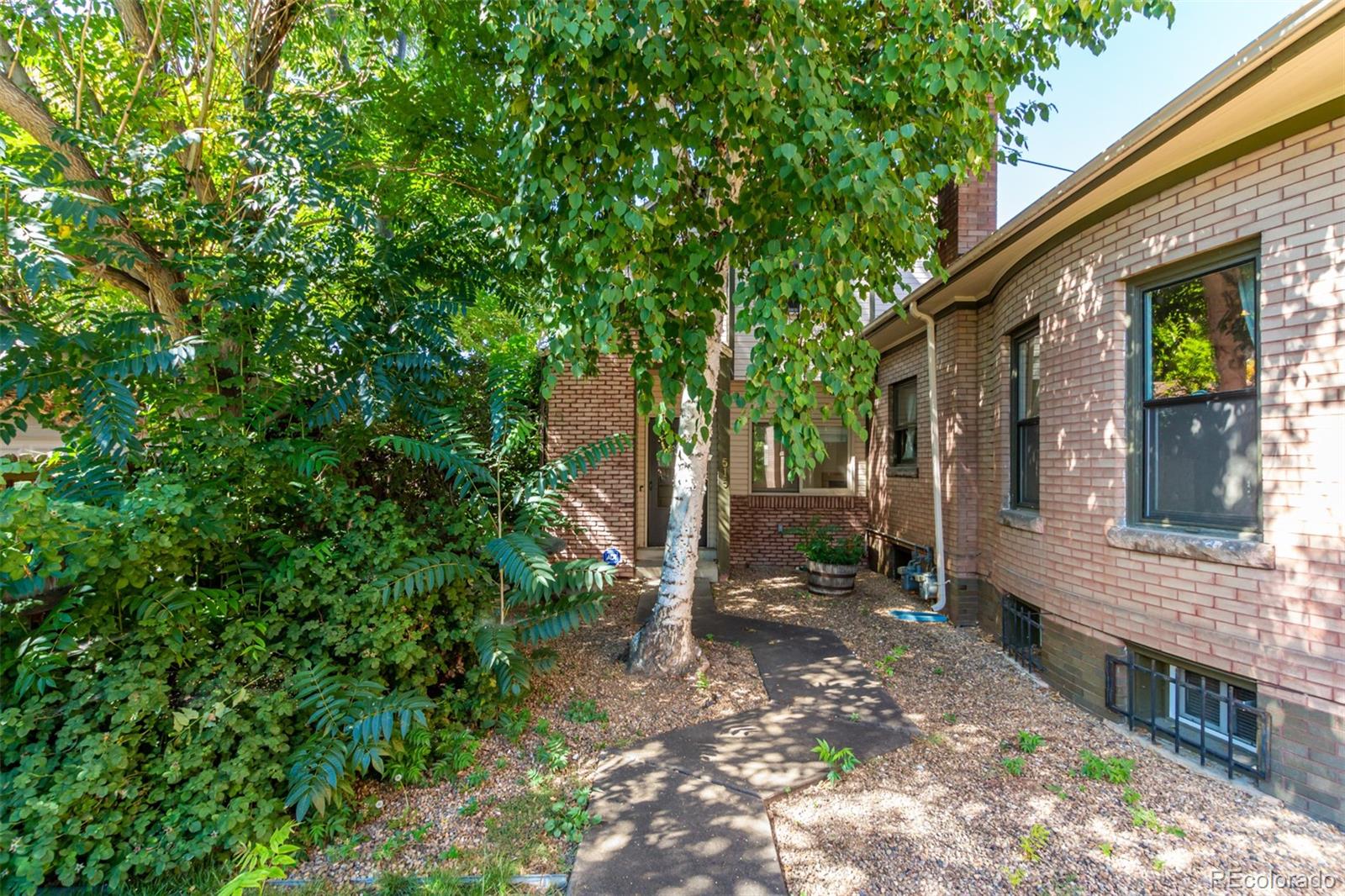 515 Cook Street Denver, CO 80206 - Photo 4 of 40 a view of a house with backyard and sitting area