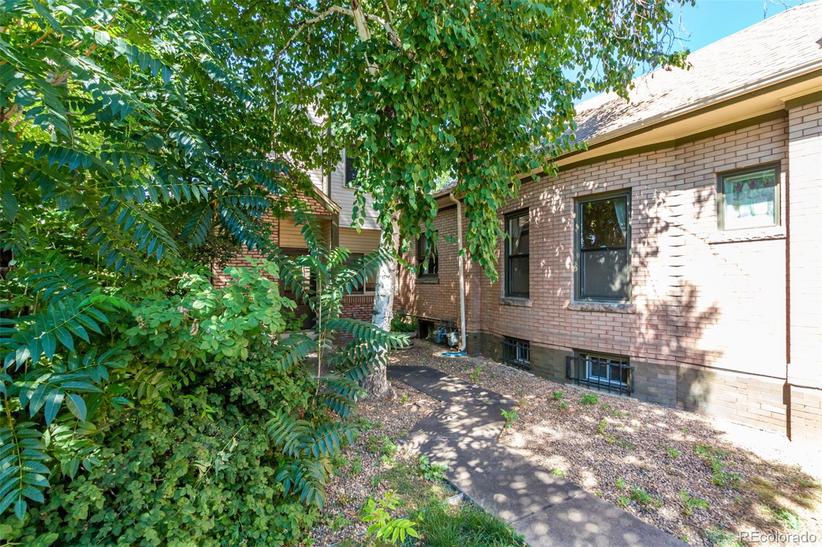 515 Cook Street Denver, CO 80206 - Photo 5 of 40 a view of a house with a tree