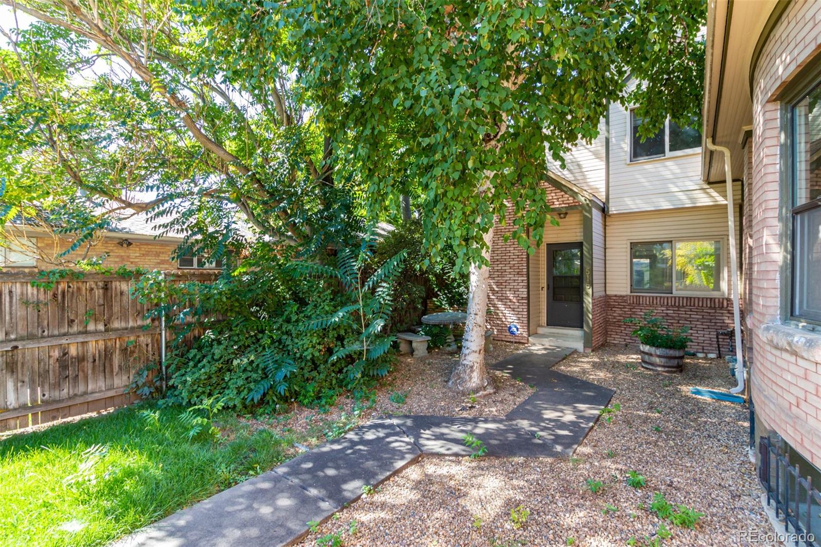515 Cook Street Denver, CO 80206 - Photo 6 of 40 a view of a backyard with plants and large trees
