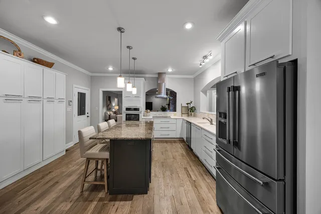 a kitchen with counter top space a sink stainless steel appliances and cabinets