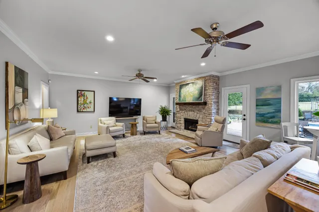 a living room with furniture a fireplace and a flat screen tv