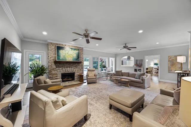 a living room with furniture a fireplace and a flat screen tv