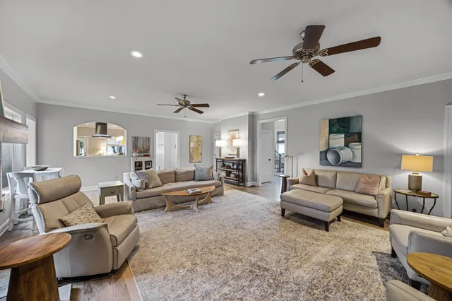 a living room with furniture and a ceiling fan