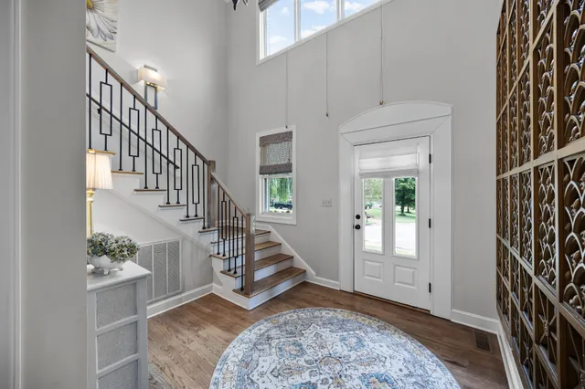 a view of entryway and hall with wooden floor