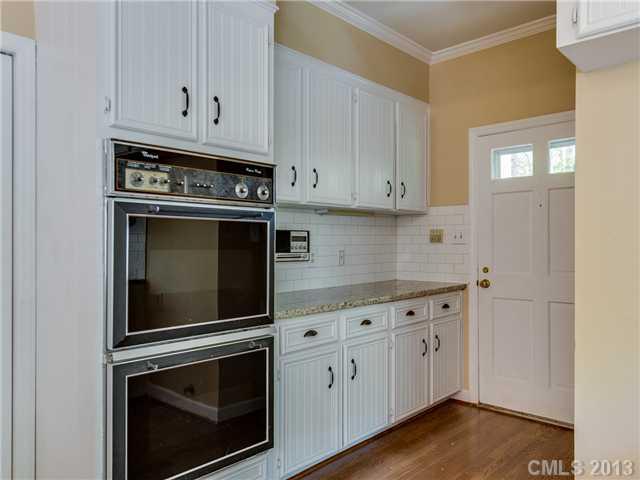 2717 High Ridge Road Charlotte, NC 28270 - Photo 5 of 16 a kitchen with granite countertop white cabinets and stainless steel appliances