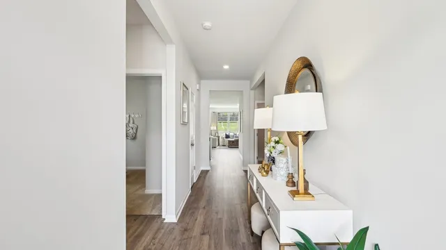 a view of a hallway with wooden floor and furniture