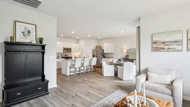 a living room with furniture and kitchen view