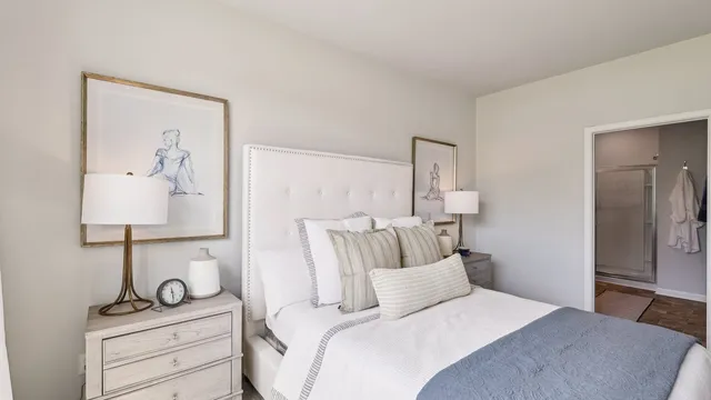 a bedroom with a bed and lamp