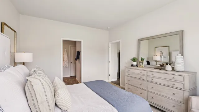 a bedroom with a bed and a dresser