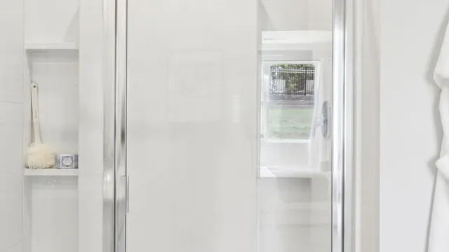 a bathroom with a glass shower door