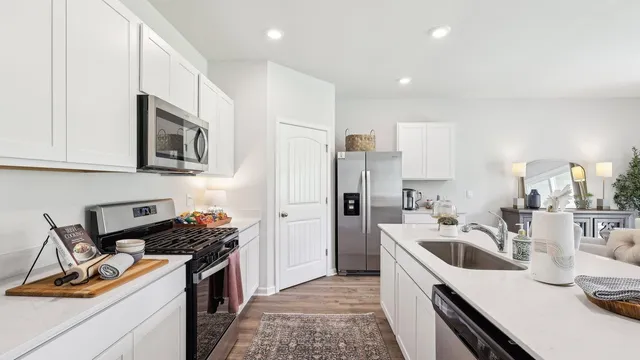 a kitchen with a sink stove and refrigerator