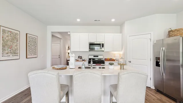 a kitchen with stainless steel appliances a refrigerator sink and microwave
