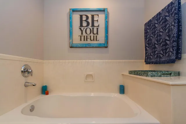 a spacious bathroom with a granite countertop sink and a mirror