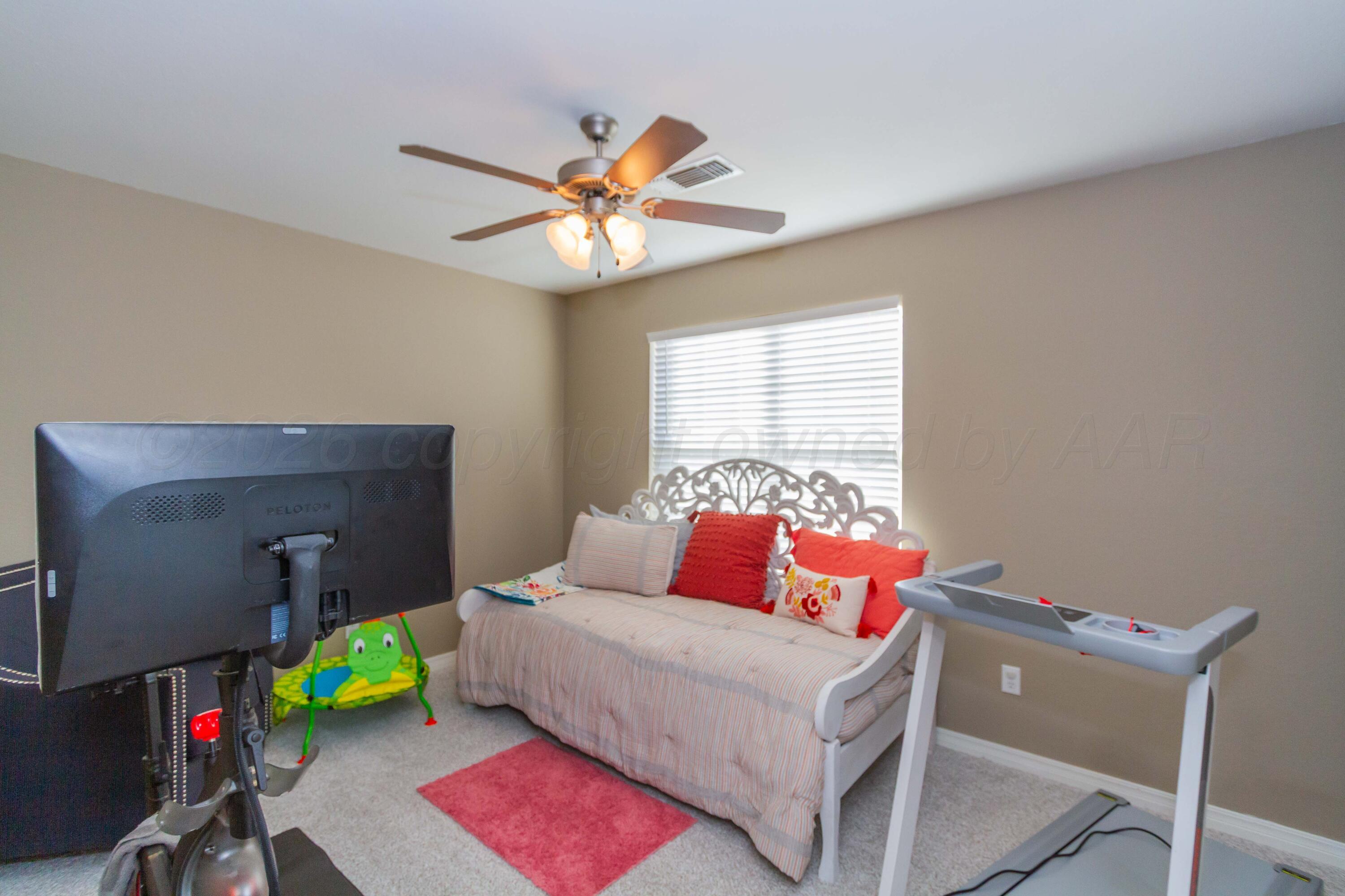 2802 Steve's Way Amarillo, TX 79118 - Photo 22 of 30 a bedroom with a bed and a chandelier