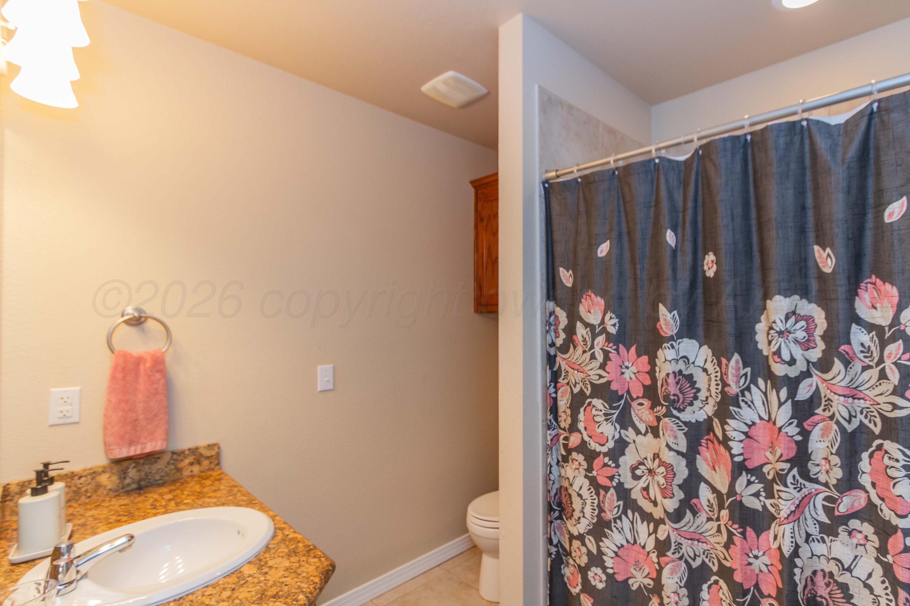 2802 Steve's Way Amarillo, TX 79118 - Photo 28 of 30 a bathroom with a granite countertop sink and a mirror