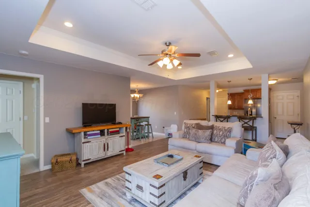 a kitchen with stainless steel appliances granite countertop a refrigerator a stove and a sink with wooden cabinets