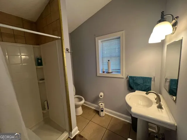 a bathroom with a sink mirror and toilet