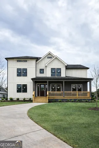 a front view of residential houses with yard and green space