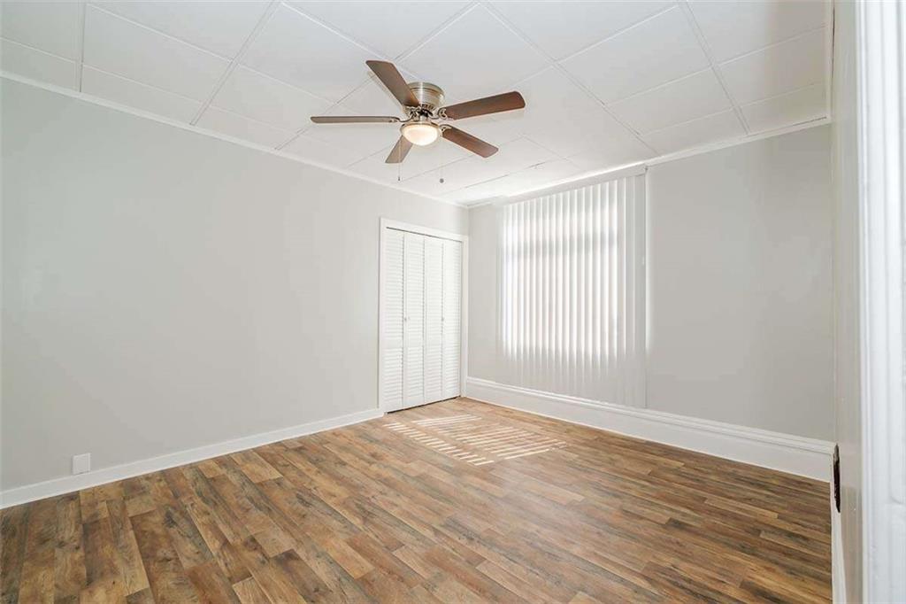 97 Royal Street Pittsburgh, PA 15212 - Photo 15 of 24 an empty room with wooden floor fan and windows