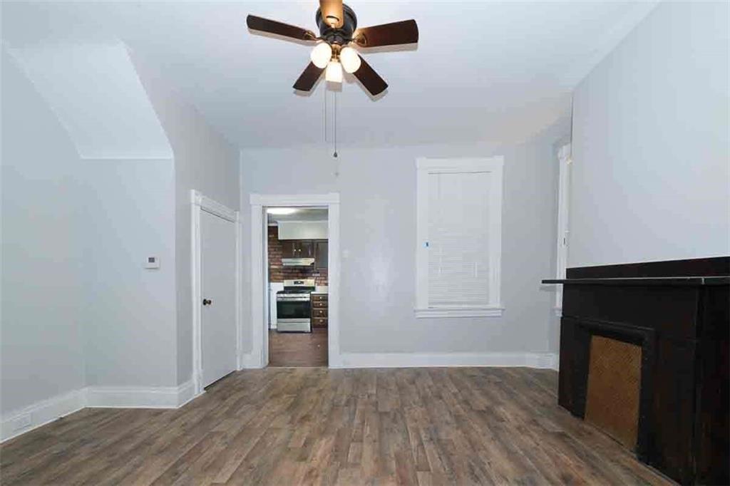 97 Royal Street Pittsburgh, PA 15212 - Photo 8 of 24 a view of empty room with wooden floor and fan