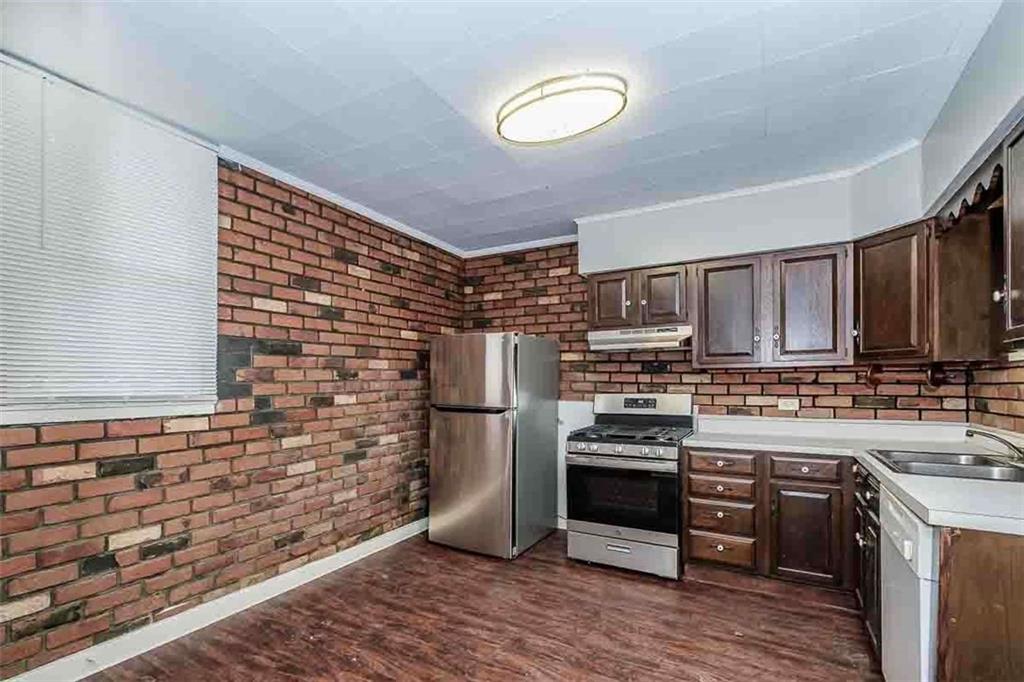 97 Royal Street Pittsburgh, PA 15212 - Photo 9 of 24 a kitchen with stainless steel appliances a stove a sink and a refrigerator