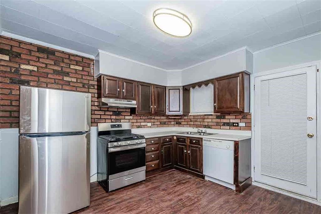 97 Royal Street Pittsburgh, PA 15212 - Photo 10 of 24 a kitchen with stainless steel appliances granite countertop a stove top oven and refrigerator
