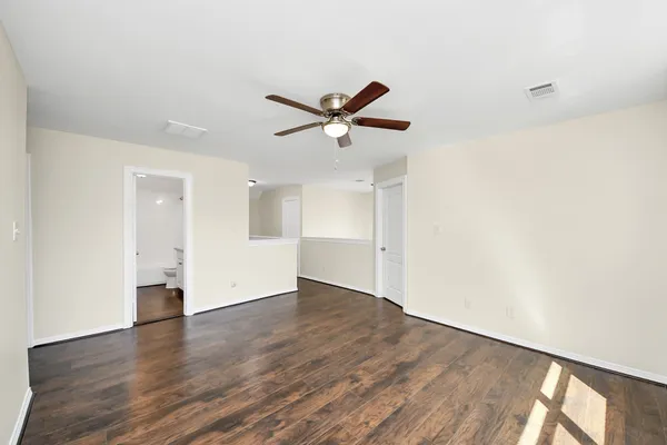 a view of a ceiling fan with wooden floor
