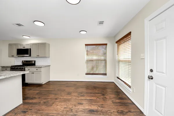 a view of a kitchen with a sink dishwasher and a microwave
