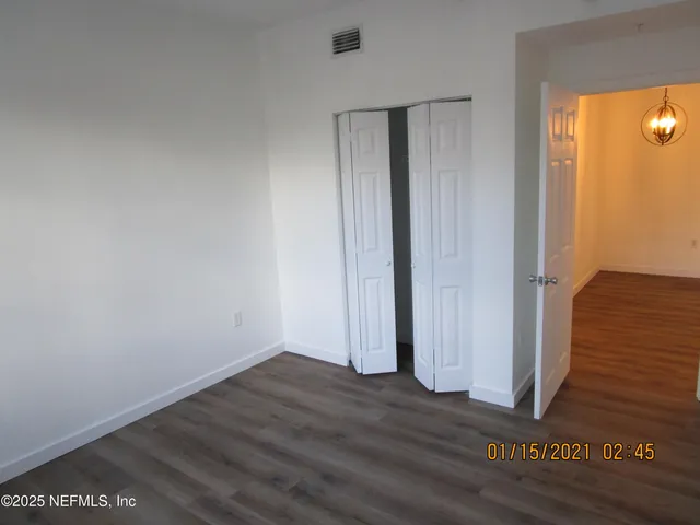 a view of a room with wooden floor