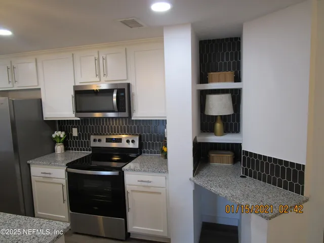 a kitchen with a stove and a microwave