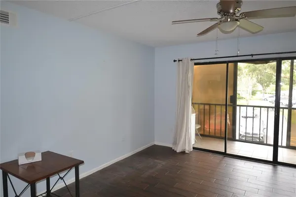 a view of a dining room with furniture a chandelier and wooden floor