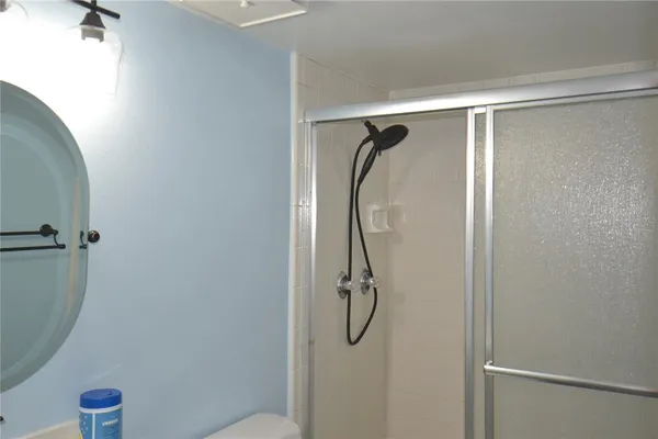 a bathroom with a shower and a shower head