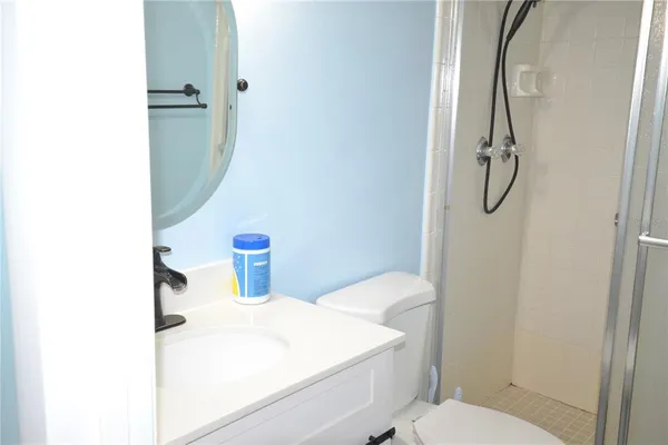 a bathroom with a toilet sink and shower curtain