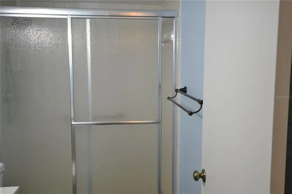 a white toilet sitting next to a shower curtain