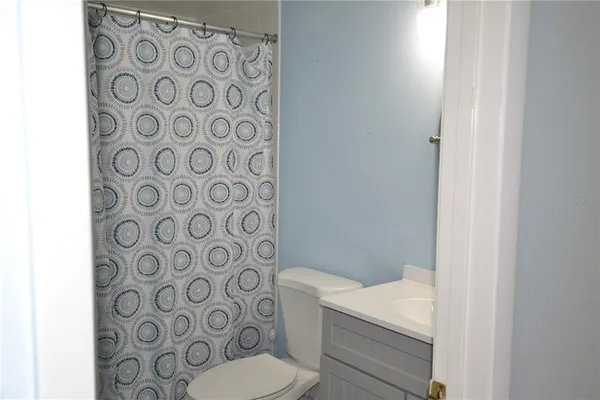 a bathroom with a shower curtain and a sink