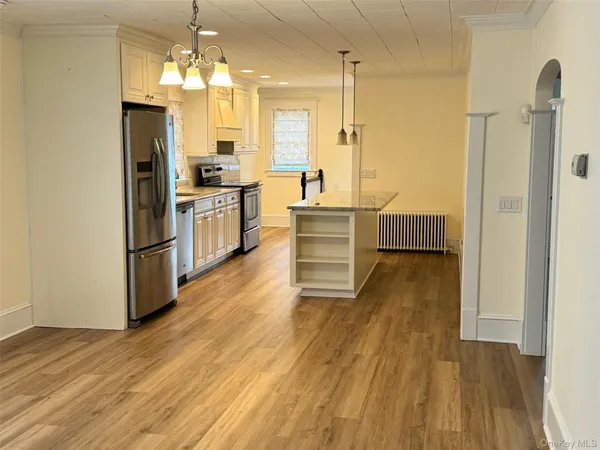 a kitchen with a sink appliances and cabinets