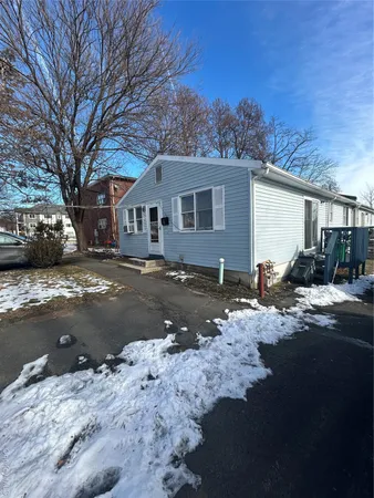 a view of a house with a yard covered in snow
