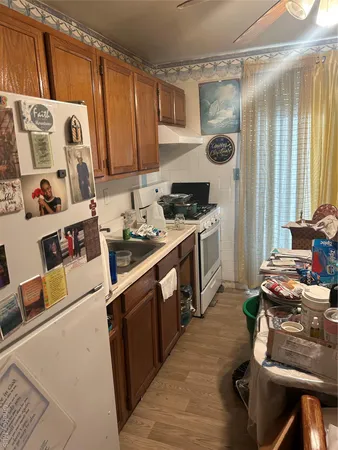 a kitchen with a stove a refrigerator and a sink
