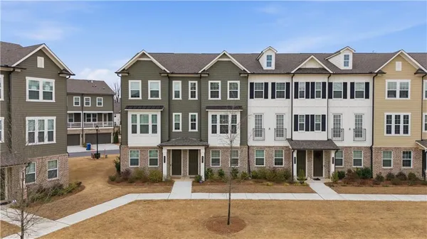 a front view of a residential apartment building with a yard