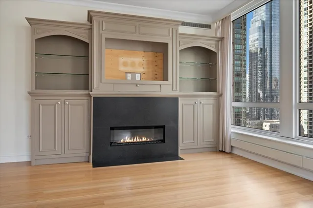 a living room with a fireplace and a large window