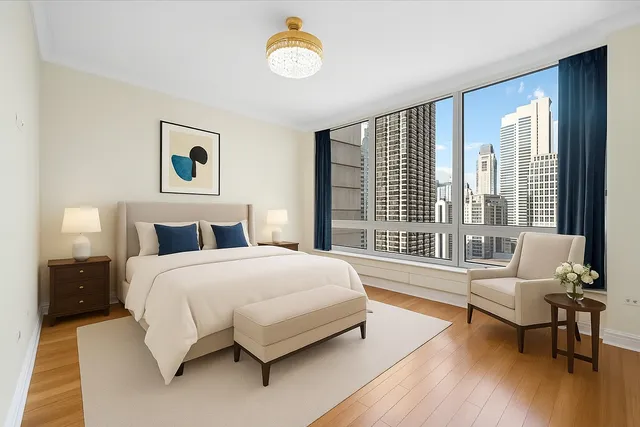 a bedroom with a bed and a large window