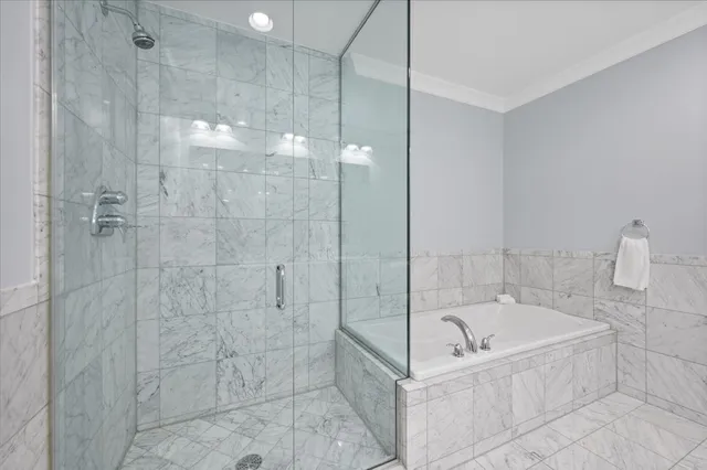 a bathroom with a bathtub and shower