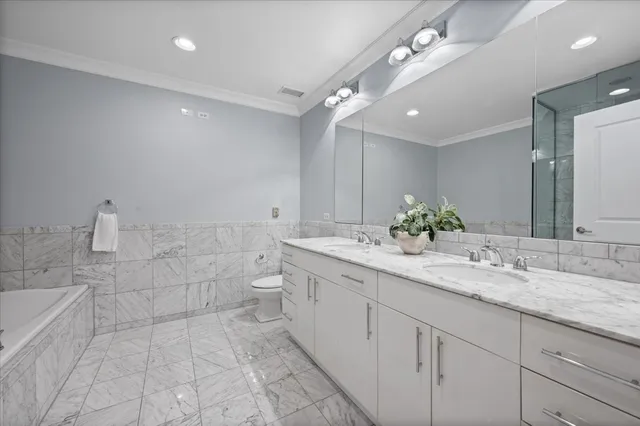 a spacious bathroom with a granite countertop sink a toilet and a mirror