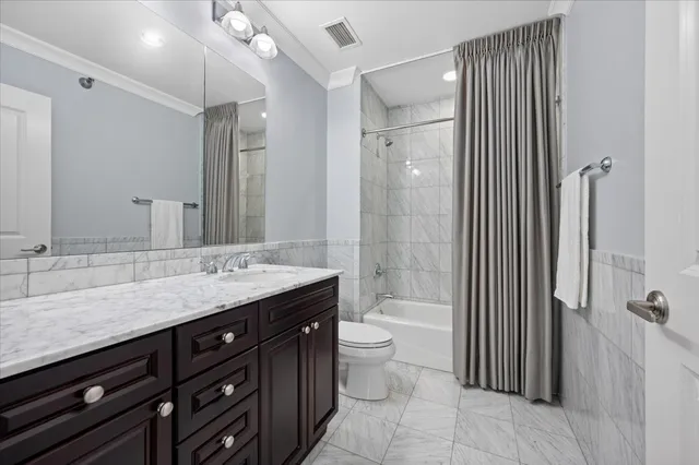 a bathroom with a granite countertop sink toilet a mirror a vanity and shower
