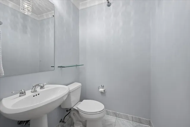 a bathroom with a sink a toilet and mirror